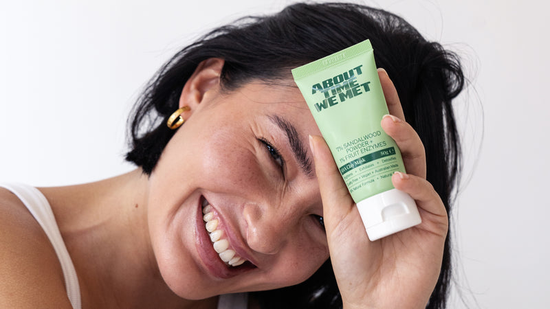 young female excited to show she is using About time we met's aha clay mask
