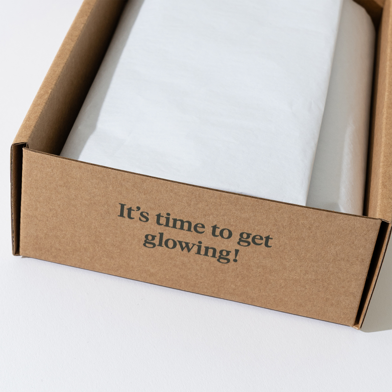 Gift box packing of Glow - to - Go serum and face cream set, ideal for skincare gifting.