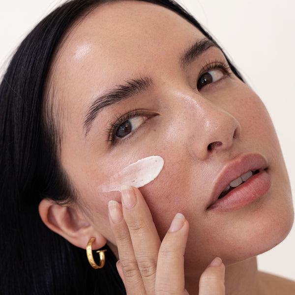young female using using About time we met's sandalwood product to reduce appearance of acne