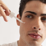 young male using About time we met's radiance serum on clean skin