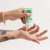 person applying About time we met's restore night cream on hands