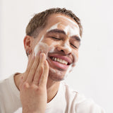 happy man using About time we met's foaming cleanser